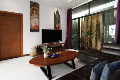 a living room with a couch and a table at Emotion 2 Villa by G Estate in Rawai Beach