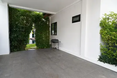 a patio with a chair in a white building at Emotion 2 Villa by G Estate in Rawai Beach
