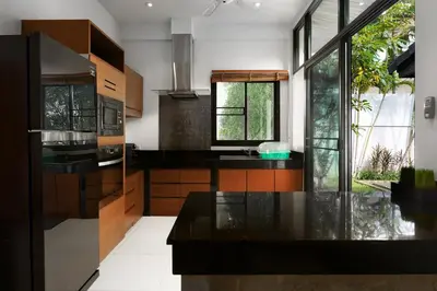 a kitchen with a black counter top and some windows at Emotion 2 Villa by G Estate in Rawai Beach