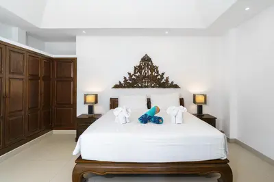 a bedroom with a white bed with a christmas tree on it at La Romanee Infinity by G Estate in Rawai Beach
