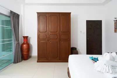 a bedroom with a bed and a vase at La Romanee Infinity by G Estate in Rawai Beach