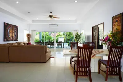 a living room with a couch and a table at La Romanee Infinity by G Estate in Rawai Beach