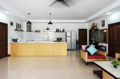 a kitchen with a yellow counter and a refrigerator at Corton Villa by G Estate in Rawai Beach