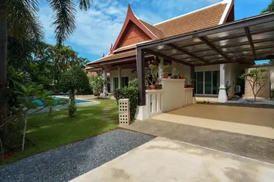 a house with a porch and a driveway at Corton Villa by G Estate in Rawai Beach