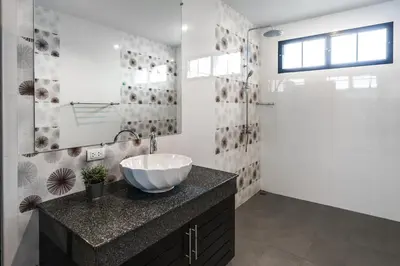 a bathroom with a bowl sink and a shower at Clos Vougeot Villa by G Estate in Rawai Beach
