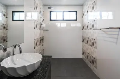 a white bathroom with a sink and a shower at Clos Vougeot Villa by G Estate in Rawai Beach