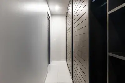a hallway with black and white walls and a door at Clos Vougeot Villa by G Estate in Rawai Beach