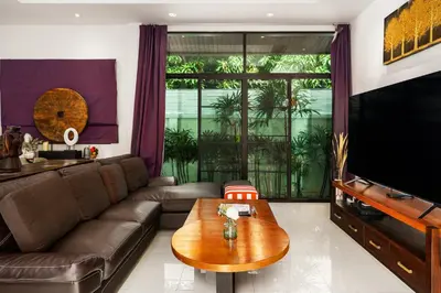 a living room with a couch and a table at Emotion 1 Villa by G Estate in Rawai Beach