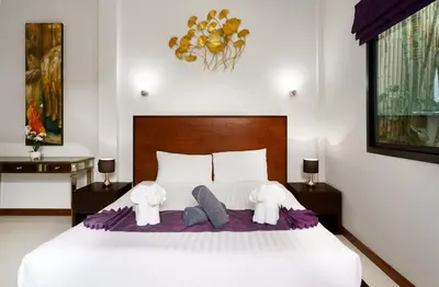 a bedroom with a white bed with two elephants on it at Emotion 1 Villa by G Estate in Rawai Beach