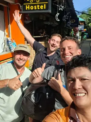 a group of men posing for a picture at Voyagers Hostel in Phi Phi Don
