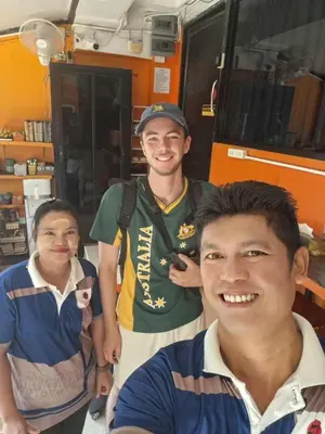 a group of men standing next to each other at Voyagers Hostel in Phi Phi Don