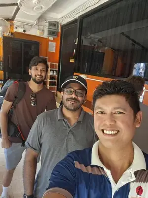 a group of men standing in front of a bus at Voyagers Hostel in Phi Phi Don