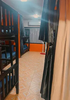 a room with two bunk beds with black leather clothes at Voyagers Hostel in Phi Phi Don