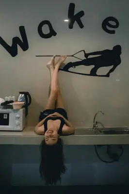 a woman laying on a counter next to a sink at Phuket Wake Park in Kathu