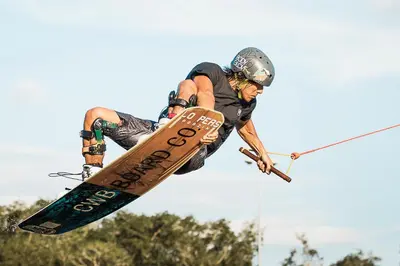 a man flying through the air on a snowboard at Phuket Wake Park in Kathu