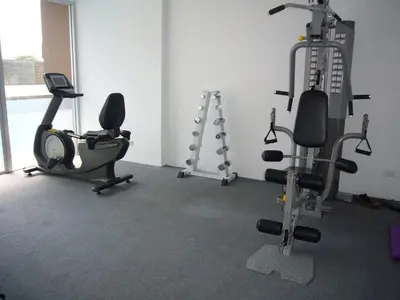 a gym with two exercise bikes and tread machines at Chic Condominium Unit A303, A306, A307, A308, A406 in Karon Beach