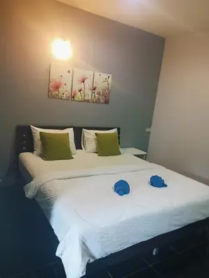 two beds in a room with two blue hats on them at Krabi Nemo House in Ao Nang Beach
