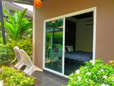 a sliding glass door leading to a patio with a bed at Nemo 2 Resort in Ao Nang Beach