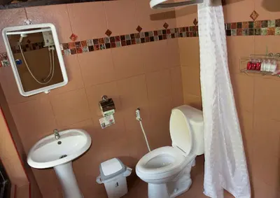 a bathroom with a toilet and a sink at Sunflower Boathouse in Phi Phi Don