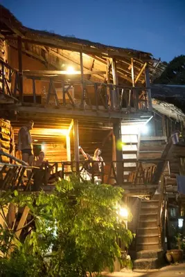 a group of people sitting outside of a building at Sunflower Boathouse in Phi Phi Don