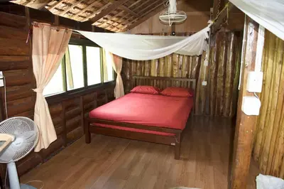a bedroom with a red bed in a cabin at Sunflower Boathouse in Phi Phi Don