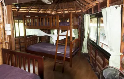 a bedroom with two bunk beds in a room at Sunflower Boathouse in Phi Phi Don