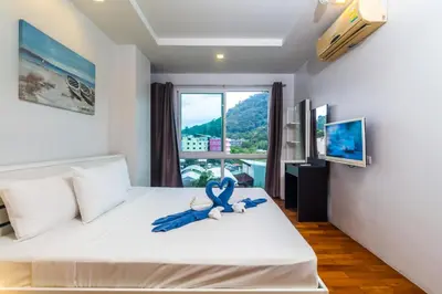 a bedroom with a bed with a blue ribbon on it at Heaven Lagoon Condo by Lofty in Patong Beach