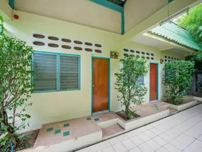 a house with two trees in front of it at Baantonsai Garden Resort in Patong Beach