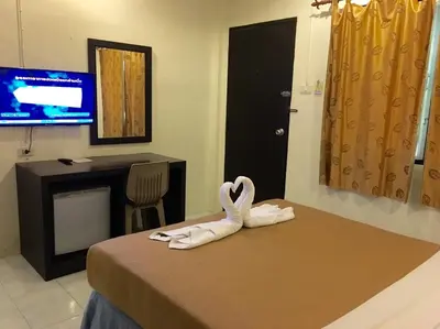 a hotel room with a swan decoration on a bed at Baantonsai Garden Resort in Patong Beach