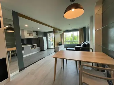 a kitchen and living room with a table and chairs at Risa Plus2 in Kathu