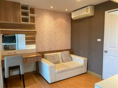 a living room with a white couch and a desk at Risa Plus2 in Kathu