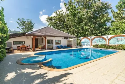 a swimming pool in the backyard of a house at Villa Andre by VillaCarte in Nai Harn Beach