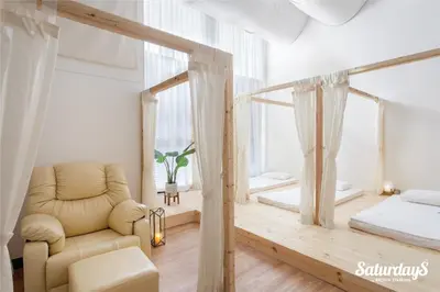a living room with a chair and a bed at Saturdays Residence by Brown Starling in Rawai Beach