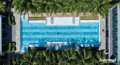 an overhead view of a swimming pool with palm trees at Saturdays Residence by Brown Starling in Rawai Beach