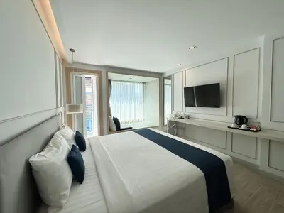 a hotel room with a bed and a television at The Bloc Hotel Phuket in Patong Beach