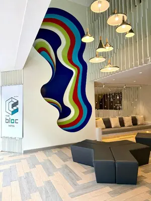 a lobby with a colorful mural on the wall at The Bloc Hotel Phuket in Patong Beach