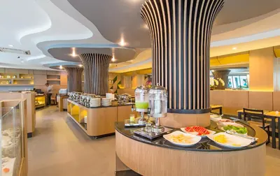 a restaurant with food on a counter and columns at AVA SEA Resort Krabi, Ao Nang Beach in Ao Nang Beach