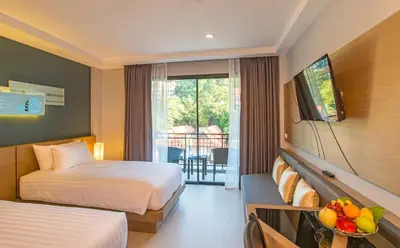 a hotel room with two beds and a balcony at AVA SEA Resort Krabi, Ao Nang Beach in Ao Nang Beach