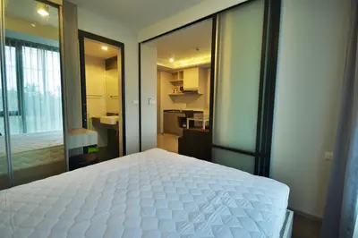 a bedroom with a large white bed in a room at 6th Avenue Surin by Risa in Surin Beach