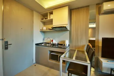 a small kitchen with a sink and a counter at 6th Avenue Surin by Risa in Surin Beach