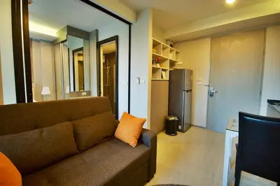 a living room with a couch and a refrigerator at 6th Avenue Surin by Risa in Surin Beach