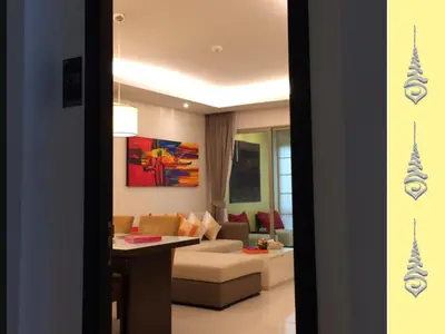 a living room with a couch and a table at Apt S104 Kamala Regent in Kamala Beach