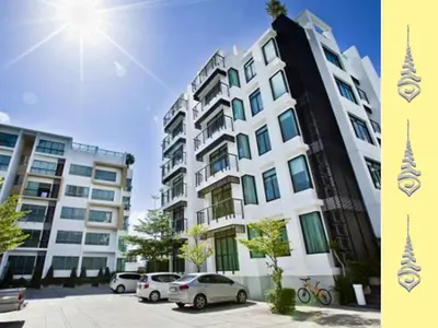 a large building with cars parked in front of it at Apt S104 Kamala Regent in Kamala Beach