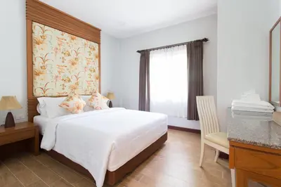a bedroom with a bed and a desk and a window at Alisea Pool Villa Aonang in Ao Nang Beach