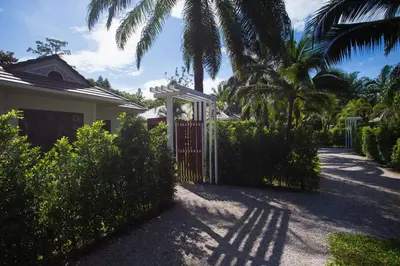 a gate in front of a house with palm trees at Alisea Pool Villa Aonang in Ao Nang Beach
