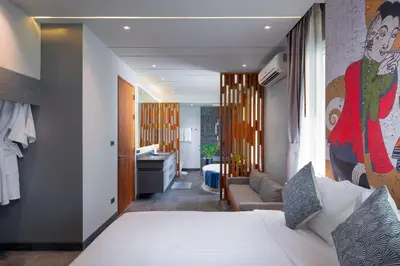 a bedroom with a bed and a living room at Karon Beach Pool Villa - Sha Extra Plus in Karon Beach