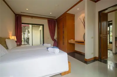 a large bedroom with two beds and a window at VILLA PAGAI Pool Baan Bua Estate Naiharn in Rawai Beach
