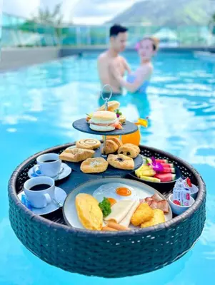 a tray of breakfast food in a swimming pool at Clarian Hotel Beach Patong in Patong Beach
