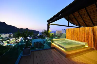 a balcony with a swimming pool on a building at Bukit Pool Villas - SHA Extra Plus in Patong Beach