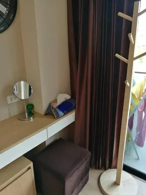 a room with a desk and a window with a stool at The Naithorn Condo Unit 401 in Nai Thon Beach